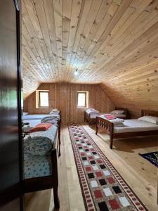a room with a bunch of beds in a cabin at Guest House Kukaj Valbone in Valbonë