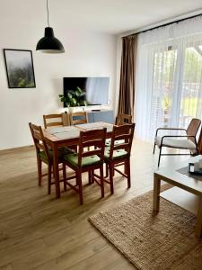 Televízia a/alebo spoločenská miestnosť v ubytovaní Apartamenty Lobeliowy Port