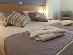 Postel nebo postele na pokoji v ubytování Apollon Hotel