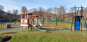 a playground with a slide in a park at Tigh na Camus in Glenelg