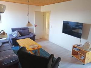 a living room with a couch and a table at Ferienwohnung "Luv" Grube Ostsee in Grube