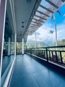 a balcony of a house with a view of the mountains at Linn View Home Stay Munnar in Munnar
