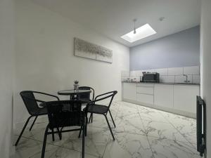 a room with a table and chairs and a kitchen at Aspire 860 in Colchester