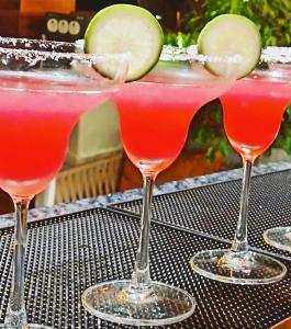 a group of three cocktails sitting on a table at CENTRAL INN in Dibrugarh