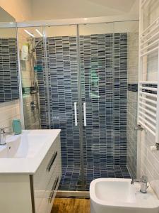 a bathroom with a sink and a glass shower at Casa Giardini in Venice