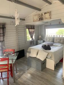 een slaapkamer met een groot bed en een tafel bij Chalet de charme tout confort in Les Adrets de l'Esterel