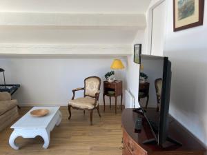 a living room with a tv and a couch and a table at Camping Mas Piques in Bourg-Madame