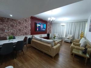 a living room with couches and a brick wall at شقة كبيرة وفخمة large and luxury two bedroom in Ajman 