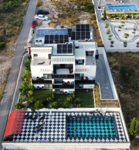 an aerial view of a house with solar panels on it at VILLA JANE INN in Rogoznica