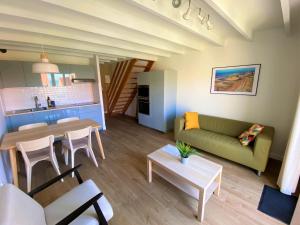 a living room with a couch and a table at Petite Opale in Ambleteuse