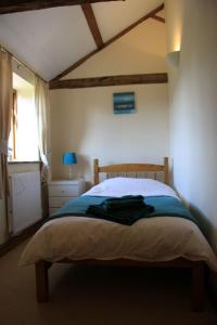 a bedroom with a bed with a wooden head board at The Granary Self Catering Cottage in Shrewsbury