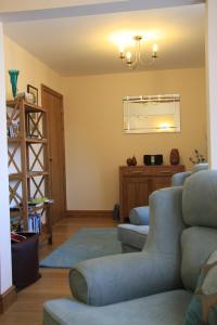 a living room with couches and a table at The Granary Self Catering Cottage in Shrewsbury