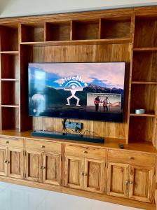 a entertainment center with a flat screen tv at Residential Resort Condo by the Bay in Manila