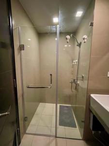 a shower with a glass door in a bathroom at Residential Resort Condo by the Bay in Manila