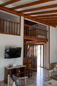 a living room with a flat screen tv on a wall at Villa Aelia in Kámpos