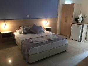Postel nebo postele na pokoji v ubytování Apollon Hotel