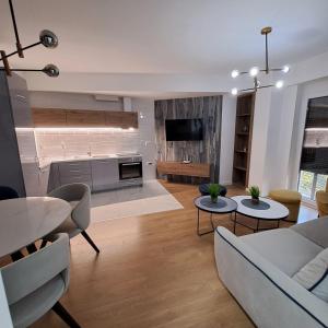a living room with a couch and a table at RINES Apartment in Ohrid
