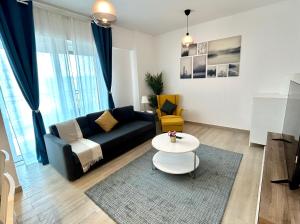 a living room with a couch and a table at OC Design at Yas Island - Deluxe Apartment in Abu Dhabi
