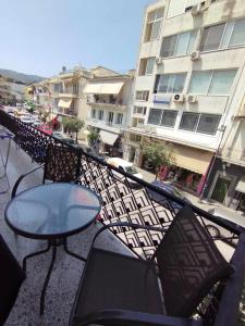 a balcony with a table and chairs and a building at Sunchaser Apartments in Igoumenitsa