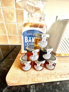 a pile of jars of back jam on a cutting board at Cosy apartment in town centre in Finedon