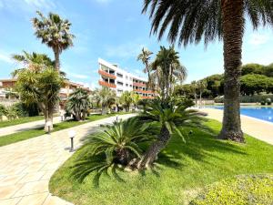 a resort with palm trees and a swimming pool at Synergie SI07 - Sol Cambrils in Cambrils