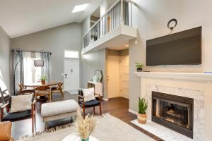 a living room with a fireplace and a tv at Charming Omaha Vacation Rental 1 Mi to Downtown! in Omaha