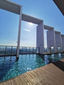 a swimming pool on top of a building with water at Harmonee Homes - Mode Chill at The Hub SS2, PJ in Petaling Jaya