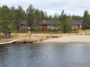 a house on the shore of a body of water at Apartment Urupaa in Saariselka