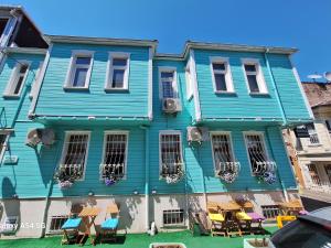 a blue house with tables and chairs in front of it at Fidelya Boutique Hotel in Sultanahmet