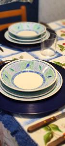 a table with plates and utensils on top of it at Casa Hena in Croviana