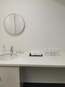 a bathroom counter with a sink and a mirror at Harmonee Homes - Mode Chill at The Hub SS2, PJ in Petaling Jaya