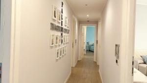 a hallway with white walls and pictures on the walls at Persiane al Cassaro in Palermo