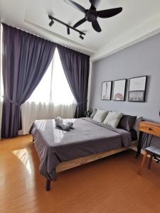 a bedroom with a bed and a ceiling fan at Harmonee Homes - Mode Chill at The Hub SS2, PJ in Petaling Jaya
