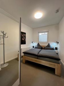 a bedroom with a bed and a cross on the wall at Kurstadtapartment Baden-Baden in Baden-Baden