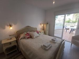 a bedroom with a bed with towels on it at Luxury Paradise Beach Villa in Vera