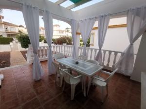 a patio with a table and chairs on a balcony at Luxury Paradise Beach Villa in Vera