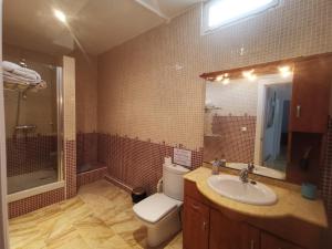 a bathroom with a toilet and a sink and a mirror at Luxury Paradise Beach Villa in Vera +30 photos