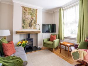 a living room with a fireplace and a tv at Pass the Keys Bath Road Retreat 2 bedrooms with garden in Cheltenham