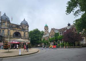 a city street with a building with a clock tower at Impeccable 1-Bed Apartment in Buxton Town Center in Buxton