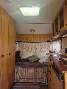 a small bedroom with a bed in a kitchen at Cozy Caravan With House Access! in Luleå
