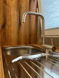 a stainless steel sink in a kitchen with a window at Kurstadtapartment Baden-Baden in Baden-Baden