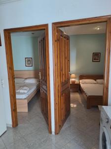 a room with two beds and two open doors at NAFPAKTOS old town in Nafpaktos