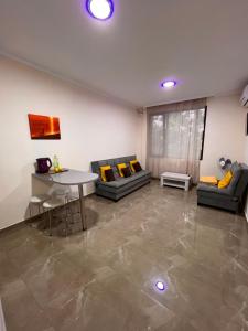 a living room with a table and two couches at Solo apartments in Ureki