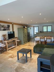 a living room with a couch and a table at Gîte la Grande Font in Saint-Capraise-dʼEymet