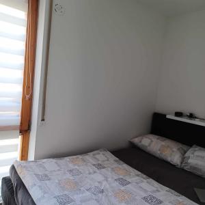 a small bedroom with a bed and a window at Apartment, Messe 5 min., City 3 min., wifi in Nuremberg