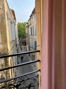 a view of a city street from a balcony at Appartement Ibiz’Arles in Arles