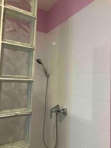 a bathroom with a shower with a glass door at Appartement Ibiz’Arles in Arles