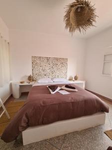a bedroom with a large bed and a table at La Maison des Vagues in Sidi Kaouki