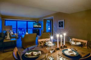 a dining room with a table and a living room at Amelia Island Oceanfront 2 Master Suites in Amelia Island