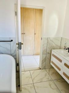 a bathroom with a shower and a toilet and a sink at Petalsoft in Pretoria